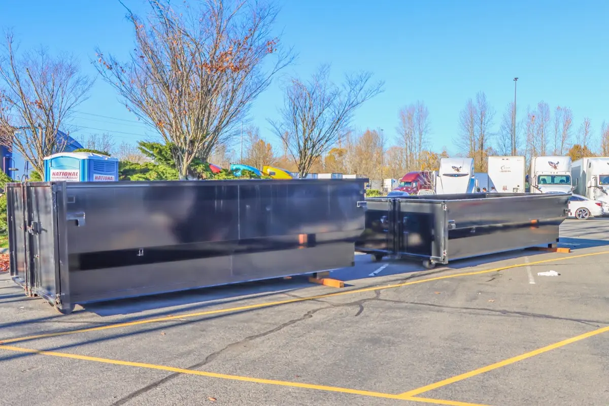 Professional dumpster rental service with roll-off container on residential driveway in Hockessin